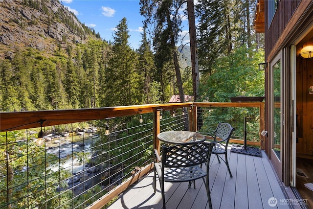 7189 Icicle Rd, Leavenworth, WA 98826 - wooden terrace with a wooded view and outdoor dining space