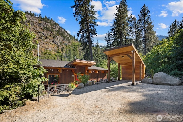 7189 Icicle Rd, Leavenworth, WA 98826 - exterior space featuring a mountain view, gravel driveway, and a forest view