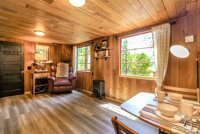 32113 Whitman Lake Dr, Graham, WA 98338 - sitting room featuring a wood stove, wooden ceiling, wood walls, and wood finished floors