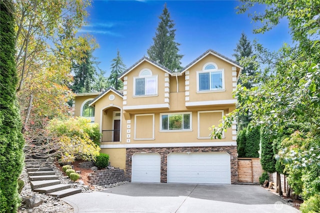 15025 SE 43rd St, Bellevue, WA 98006 - view of front of house featuring stucco siding, concrete driveway, stone siding, and an attached garage