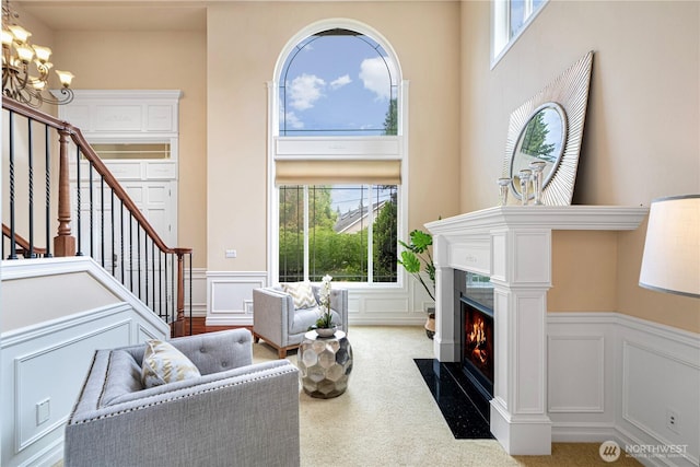 15025 SE 43rd St, Bellevue, WA 98006 - living room with a decorative wall, stairs, a high end fireplace, a wainscoted wall, and healthy amount of natural light
