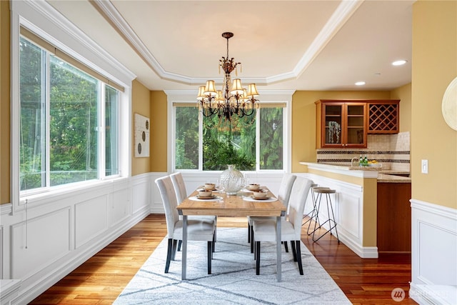 15025 SE 43rd St, Bellevue, WA 98006 - dining area with a chandelier, wood finished floors, a decorative wall, a wainscoted wall, and a raised ceiling