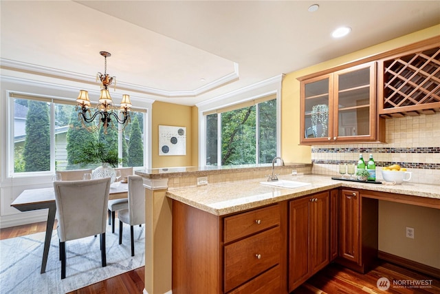 15025 SE 43rd St, Bellevue, WA 98006 - kitchen featuring wood finished floors, light stone countertops, glass insert cabinets, brown cabinets, and recessed lighting