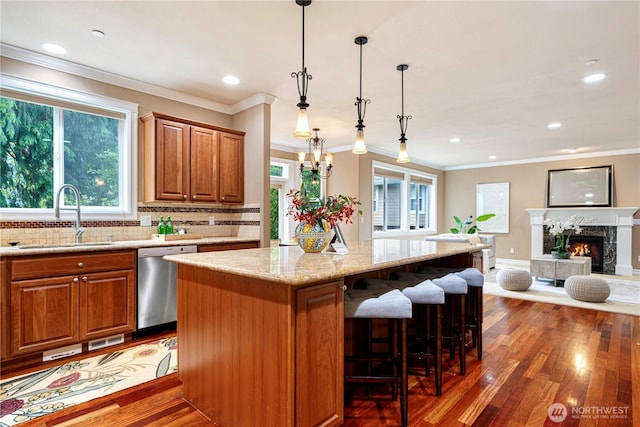 15025 SE 43rd St, Bellevue, WA 98006 - kitchen featuring dishwasher, wood finished floors, light stone counters, brown cabinets, and decorative backsplash