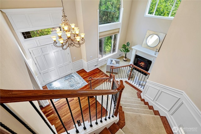 15025 SE 43rd St, Bellevue, WA 98006 - foyer featuring a decorative wall, a chandelier, a towering ceiling, stairs, and wainscoting