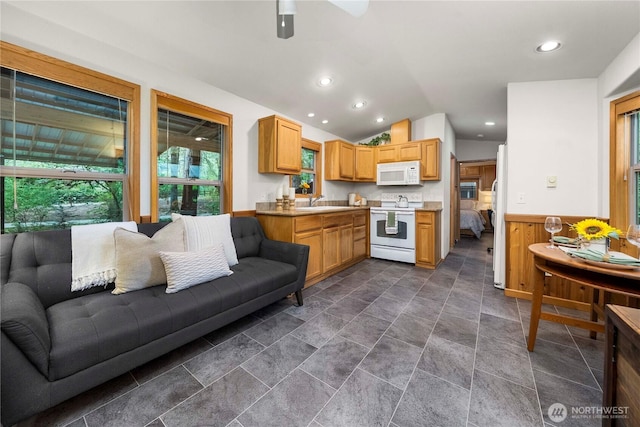 1546 Reservation Rd SE Unit 62, Olympia, WA 98513 - kitchen with white appliances, open floor plan, vaulted ceiling, wainscoting, and ceiling fan