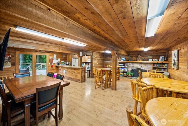 1546 Reservation Rd SE Unit 62, Olympia, WA 98513 - dining space featuring wooden walls, wood ceiling, light wood finished floors, a brick fireplace, and french doors