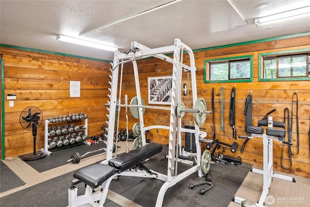 1546 Reservation Rd SE Unit 62, Olympia, WA 98513 - exercise room featuring wooden walls and a textured ceiling