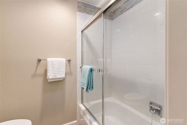 22315 6th Ave S Unit A109, Des Moines, WA 98198 - full bathroom with bath / shower combo with glass door and a textured wall