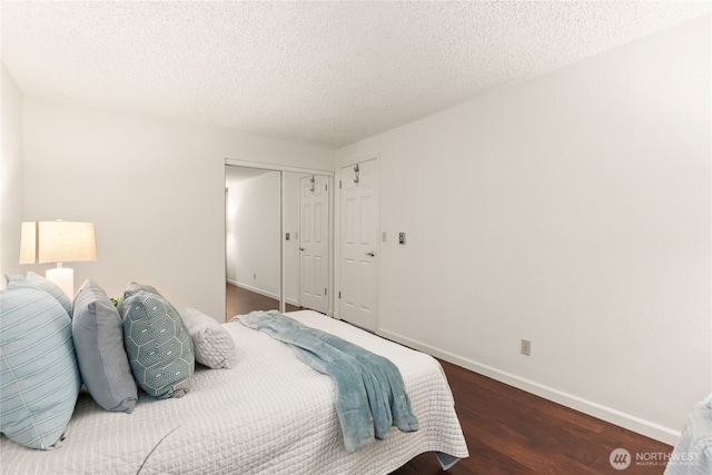 22315 6th Ave S Unit A109, Des Moines, WA 98198 - bedroom featuring wood finished floors, a closet, and a textured ceiling
