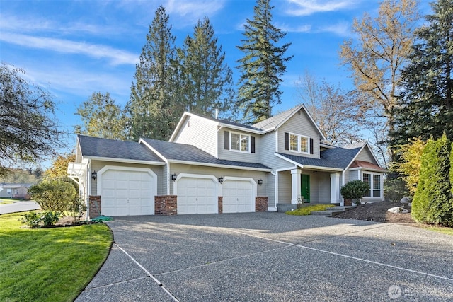 11511 188th St SE, Snohomish, WA 98296 - view of front facade featuring driveway, a garage, brick siding, and a front yard