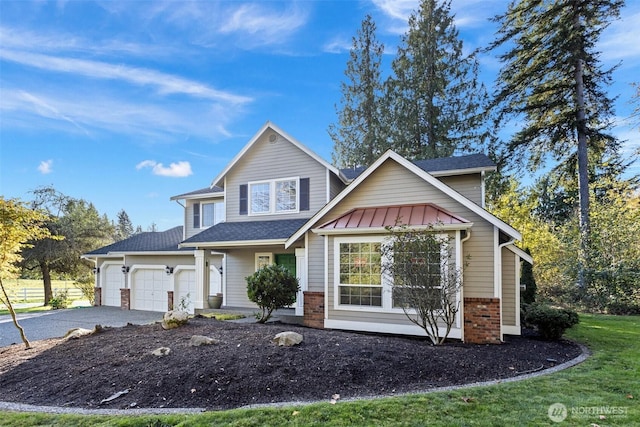 11511 188th St SE, Snohomish, WA 98296 - view of front of property featuring asphalt driveway, an attached garage, brick siding, and a front yard