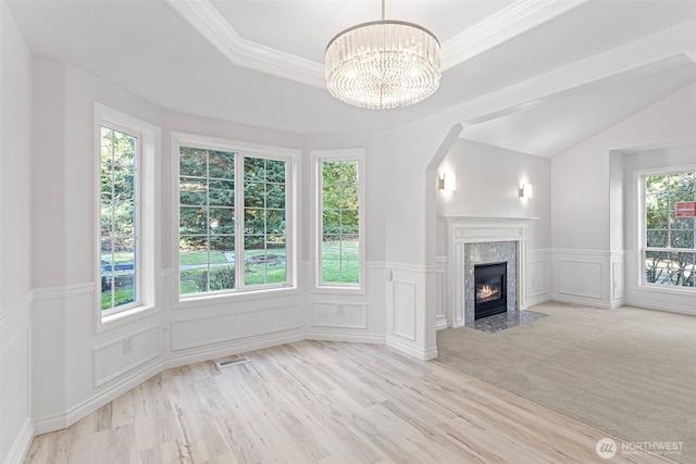 11511 188th St SE, Snohomish, WA 98296 - unfurnished living room with a decorative wall, a chandelier, wood finished floors, a premium fireplace, and a wainscoted wall