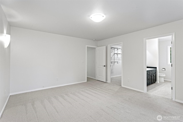 11511 188th St SE, Snohomish, WA 98296 - unfurnished bedroom featuring light colored carpet, a walk in closet, and ensuite bathroom