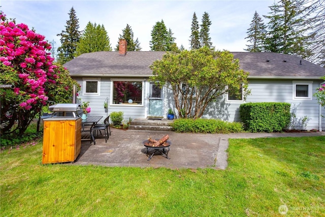 1209 Yew St, Bellingham, WA 98229 - rear view of property with a patio, a fire pit, a yard, and a chimney