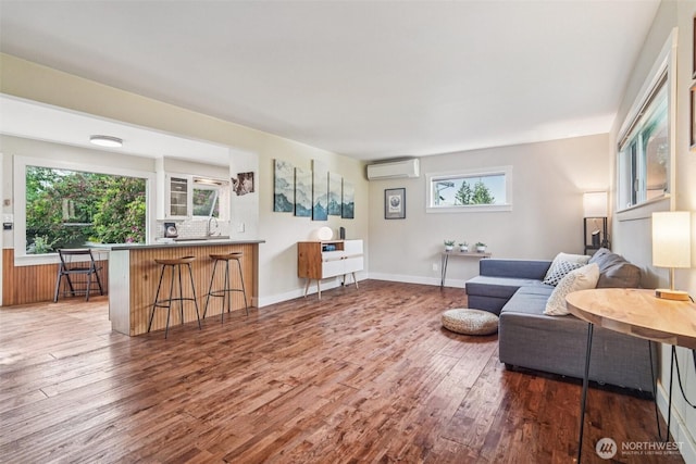 1209 Yew St, Bellingham, WA 98229 - living room with a wall unit AC, wood finished floors, and plenty of natural light