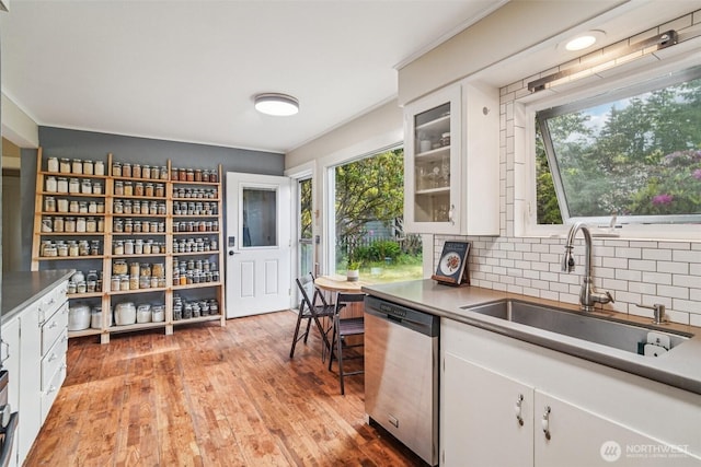 1209 Yew St, Bellingham, WA 98229 - kitchen featuring dishwasher, white cabinets, decorative backsplash, and light wood-style flooring