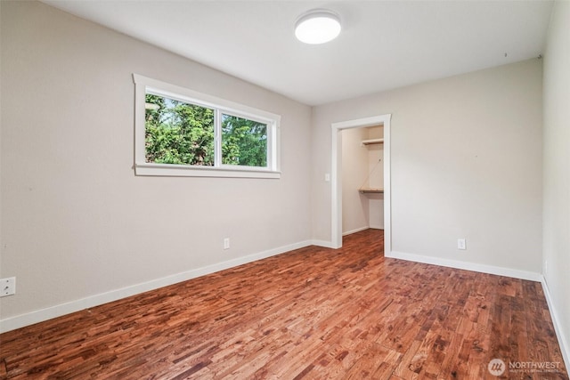 1209 Yew St, Bellingham, WA 98229 - unfurnished bedroom featuring wood finished floors and a walk in closet