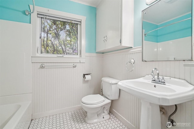 1209 Yew St, Bellingham, WA 98229 - bathroom with wainscoting,  shower combination, ornamental molding, and tile patterned floors