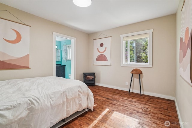 1209 Yew St, Bellingham, WA 98229 - bedroom featuring a wood stove, wood finished floors, and ensuite bathroom