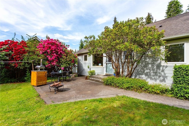 1209 Yew St, Bellingham, WA 98229 - view of grassy yard featuring an outdoor fire pit and a patio area