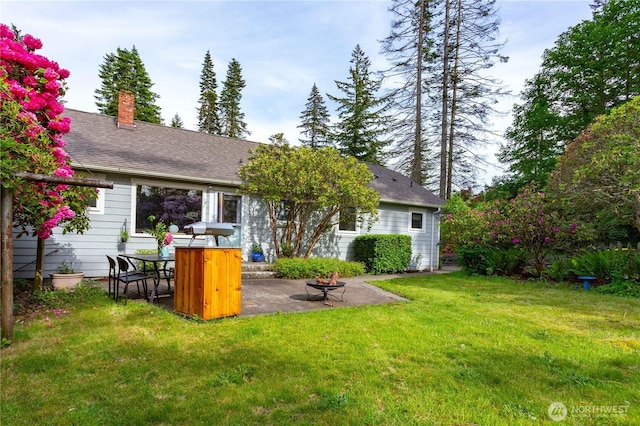 1209 Yew St, Bellingham, WA 98229 - rear view of house featuring a patio, a yard, a chimney, and a fire pit