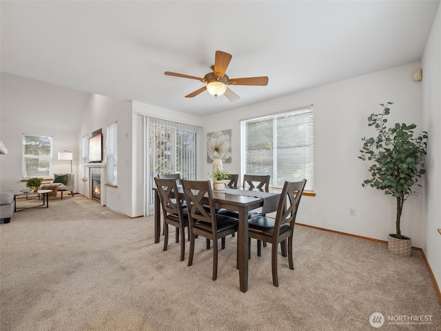 36261 23rd Pl S, Federal Way, WA 98003 - dining space featuring light carpet, a ceiling fan, and a glass covered fireplace
