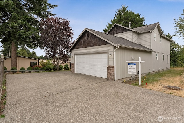 36261 23rd Pl S, Federal Way, WA 98003 - view of side of home featuring driveway, an attached garage, and a shingled roof