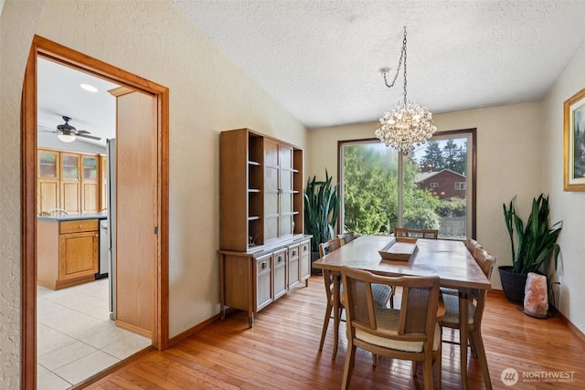 17837 Ashworth Ave N, Shoreline, WA 98133 - dining room with a textured ceiling, a chandelier, light wood-type flooring, a textured wall, and ceiling fan