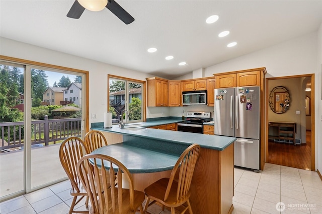 17837 Ashworth Ave N, Shoreline, WA 98133 - kitchen with appliances with stainless steel finishes, light tile patterned floors, lofted ceiling, a ceiling fan, and recessed lighting