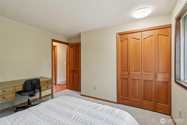 17837 Ashworth Ave N, Shoreline, WA 98133 - bedroom featuring a textured ceiling, light carpet, a textured wall, a desk, and a closet