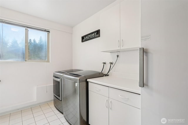 17837 Ashworth Ave N, Shoreline, WA 98133 - laundry area featuring cabinet space, washer and dryer, and light tile patterned floors
