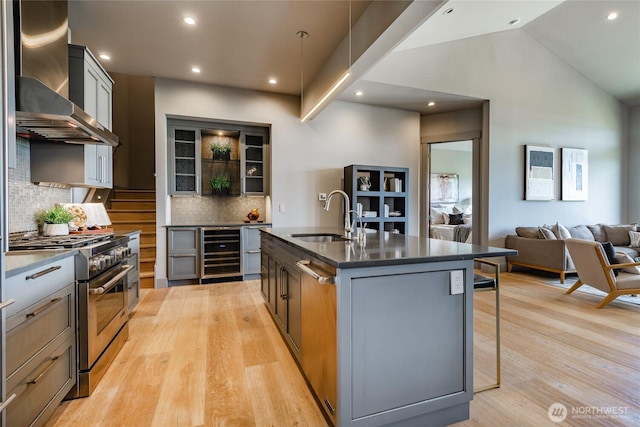 9424 Turnstone Ln Unit 29, Blaine, WA 98230 - kitchen featuring high end stainless steel range oven, wall chimney range hood, wine cooler, dark countertops, and a breakfast bar