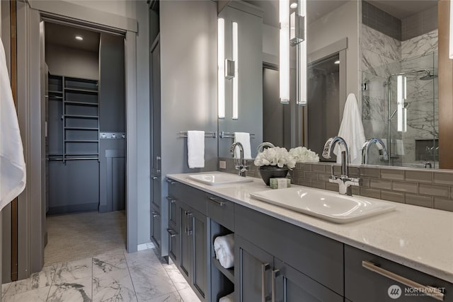 9424 Turnstone Ln Unit 29, Blaine, WA 98230 - bathroom featuring marble look tile flooring, double vanity, a stall shower, and a walk in closet
