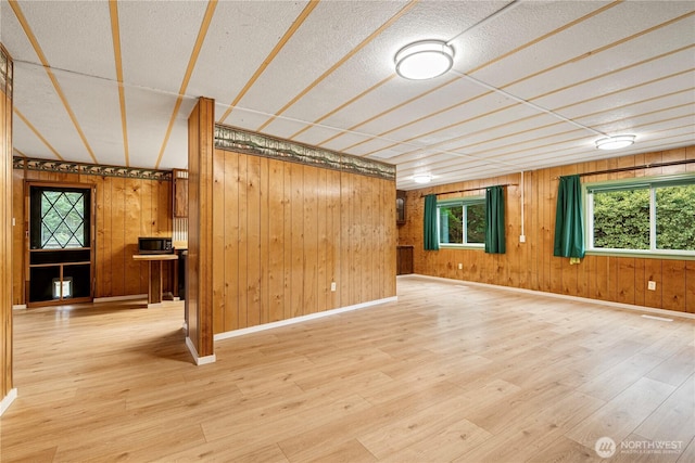 13632 SE 197th Pl, Renton, WA 98058 - unfurnished living room with wooden walls, wood finished floors, and a textured ceiling