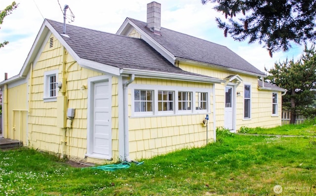 835 J St, Port Townsend, WA 98368 - back of property with a yard, roof with shingles, and a chimney