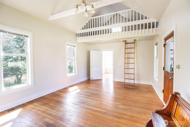 835 J St, Port Townsend, WA 98368 - entryway with light wood finished floors, high vaulted ceiling, and a chandelier