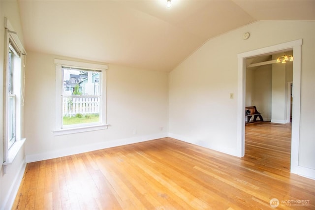835 J St, Port Townsend, WA 98368 - unfurnished room with light wood finished floors, vaulted ceiling, a smoke detector, and a chandelier