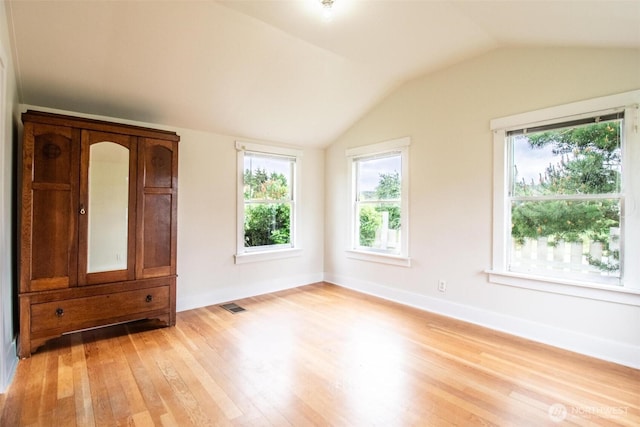 835 J St, Port Townsend, WA 98368 - unfurnished room featuring light wood-style floors, healthy amount of natural light, and vaulted ceiling