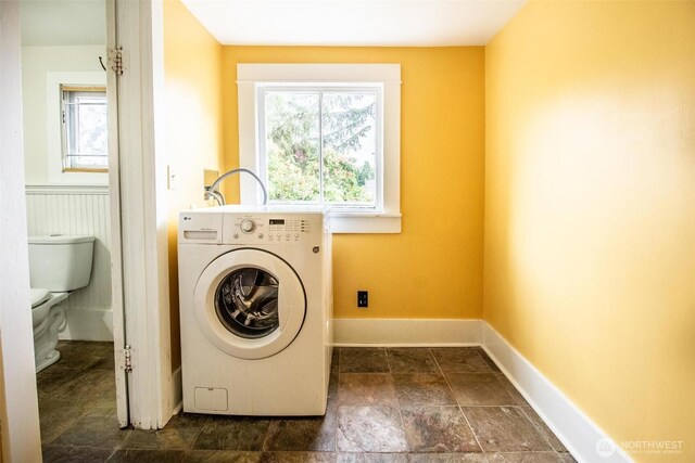 835 J St, Port Townsend, WA 98368 - laundry room featuring washer / clothes dryer and dark stone finish flooring