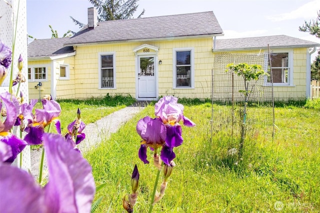 835 J St, Port Townsend, WA 98368 - view of front of home with a chimney, roof with shingles, and a front lawn