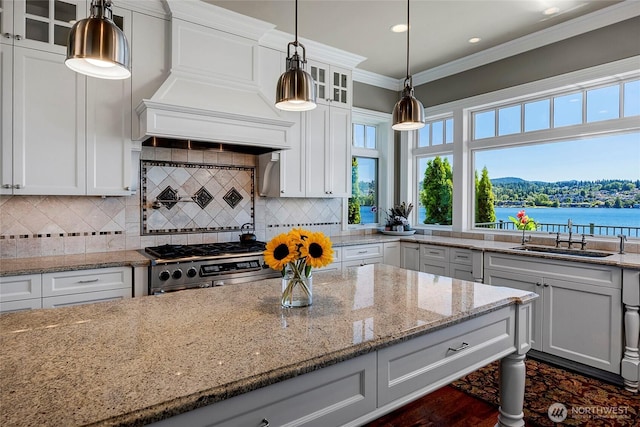 8066 Avalon Pl, Mercer Island, WA 98040 - kitchen featuring stainless steel gas range oven, glass insert cabinets, custom exhaust hood, white cabinets, and ornamental molding