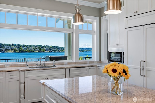 8066 Avalon Pl, Mercer Island, WA 98040 - kitchen featuring white cabinetry, stainless steel microwave, ornamental molding, hanging light fixtures, and light stone countertops