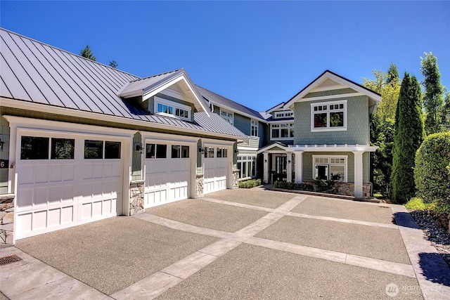 8066 Avalon Pl, Mercer Island, WA 98040 - view of front of home with a standing seam roof, stone siding, a metal roof, and driveway