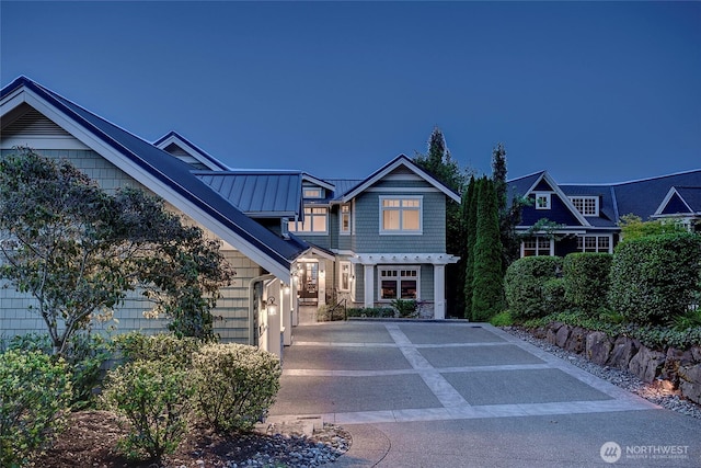 8066 Avalon Pl, Mercer Island, WA 98040 - view of front of house featuring a standing seam roof, a metal roof, and concrete driveway