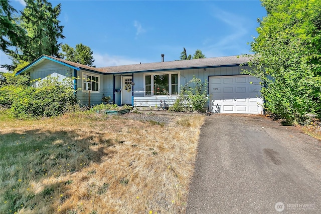 15414 121st Avenue Ct E, Puyallup, WA 98374 - ranch-style home with an attached garage, board and batten siding, and driveway