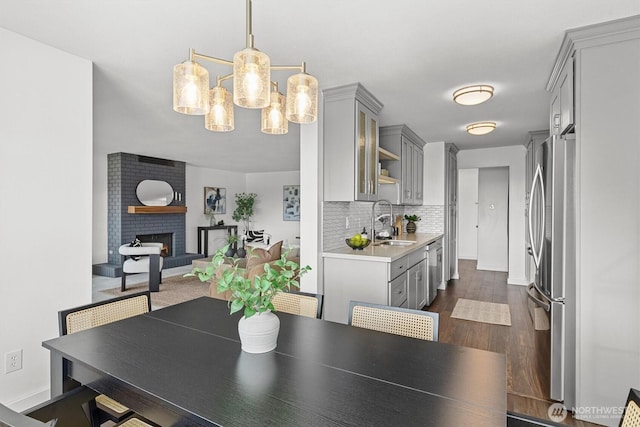 4545 Sand Point Way NE Unit 806, Seattle, WA 98105 - dining room featuring a chandelier, dark wood-type flooring, and a brick fireplace