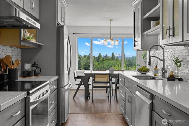 4545 Sand Point Way NE Unit 806, Seattle, WA 98105 - kitchen featuring under cabinet range hood, appliances with stainless steel finishes, gray cabinetry, and open shelves