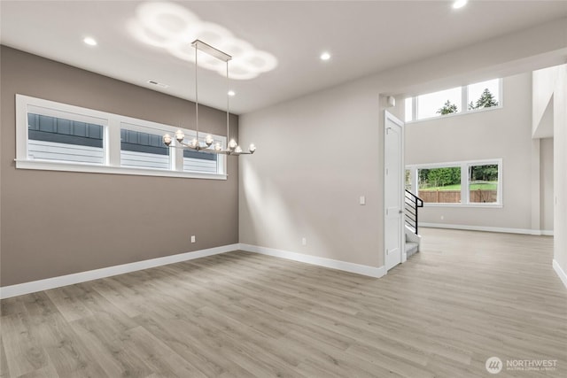 14449 133rd Pl NE, Woodinville, WA 98072 - empty room featuring a chandelier, stairs, light wood finished floors, and recessed lighting