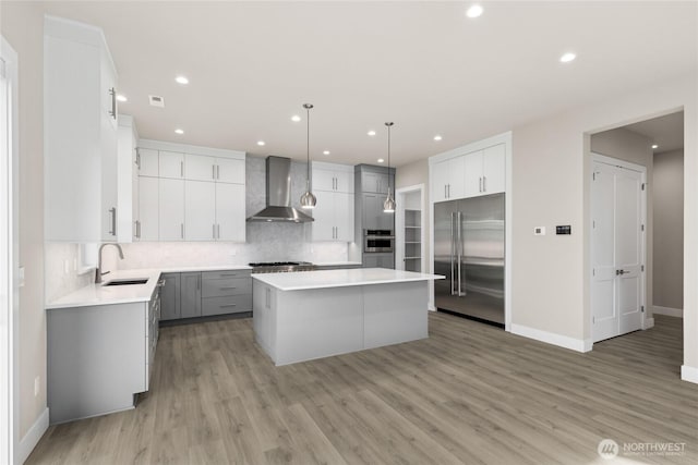 14449 133rd Pl NE, Woodinville, WA 98072 - kitchen with appliances with stainless steel finishes, wall chimney exhaust hood, a center island, decorative backsplash, and recessed lighting